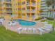 Community pool with lounge chairs and patio area at 701 N Atlantic Ave # 203, New Smyrna Beach, FL 32169