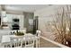 Bright dining area with white table and chairs, beach mural at 801 Sandpiper Ave, New Smyrna Beach, FL 32169