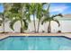 Private pool with palm trees and white vinyl fencing at 827 Hope Ave, New Smyrna Beach, FL 32169