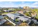 Aerial view of a modern house with a gray roof, white fence, and a pool, next to the ocean at 833 E 26Th Ave, New Smyrna Beach, FL 32169