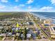 An aerial view showcasing a coastal town with houses, buildings and the beach in the background at 833 E 26Th Ave, New Smyrna Beach, FL 32169