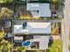An aerial view of a home with pool, visible roof and expansive property, highlighting its curb appeal at 833 E 26Th Ave, New Smyrna Beach, FL 32169