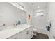 Modern bathroom featuring white cabinetry, marble countertop, and subway tile shower at 833 E 26Th Ave, New Smyrna Beach, FL 32169