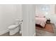 View of the toilet and a glimpse into the adjacent bedroom at 833 E 26Th Ave, New Smyrna Beach, FL 32169