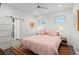 Inviting bedroom with a pink comforter, striped rug, and ensuite bathroom access at 833 E 26Th Ave, New Smyrna Beach, FL 32169