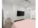 Bedroom with mounted TV, sliding barn doors, and wood-look flooring at 833 E 26Th Ave, New Smyrna Beach, FL 32169