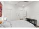 Simple white bedroom with light wood-look floors, ceiling fan and modern decor at 833 E 26Th Ave, New Smyrna Beach, FL 32169