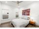 Bright bedroom with wood-look flooring, ceiling fan, and colorful artwork at 833 E 26Th Ave, New Smyrna Beach, FL 32169