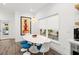 Modern dining area with a white tulip table and blue chairs at 833 E 26Th Ave, New Smyrna Beach, FL 32169