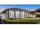 A modern, gray two-story home at night with white trim, landscaping, and walkway at 833 E 26Th Ave, New Smyrna Beach, FL 32169
