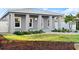 Charming single-story home with a light blue door, front yard landscaping, and a metal roof at 833 E 26Th Ave, New Smyrna Beach, FL 32169