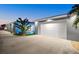 A house's exterior with garage, driveway, and a small, illuminated pool at 833 E 26Th Ave, New Smyrna Beach, FL 32169