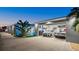 A garage interior with two parked cars, storage racks, and a pool visible through the open door at 833 E 26Th Ave, New Smyrna Beach, FL 32169