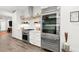 Modern kitchen with a glass-door refrigerator, gas range, and ample counter space at 833 E 26Th Ave, New Smyrna Beach, FL 32169