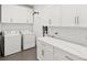 Laundry room with white shaker cabinets, quartz countertop, and washer/dryer at 833 E 26Th Ave, New Smyrna Beach, FL 32169