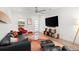 Stylish living room with modern furniture, wood floors, and a ceiling fan at 833 E 26Th Ave, New Smyrna Beach, FL 32169