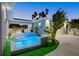 Beautiful pool with blue mosaic tile, lush landscaping, outdoor shower, and a view of the home's exterior at 833 E 26Th Ave, New Smyrna Beach, FL 32169