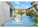 This beautiful pool features blue tiles and an outdoor shower at 833 E 26Th Ave, New Smyrna Beach, FL 32169