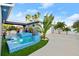 View of pool, spa, and lush tropical plants at 833 E 26Th Ave, New Smyrna Beach, FL 32169