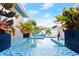 Close-up view of a pool with blue tiles and lush plants at 833 E 26Th Ave, New Smyrna Beach, FL 32169