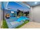 Stunning pool and spa with blue mosaic tile and lush landscaping at twilight at 833 E 26Th Ave, New Smyrna Beach, FL 32169