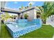 A stunning blue tiled pool and spa with a waterfall feature at 833 E 26Th Ave, New Smyrna Beach, FL 32169