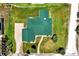 Aerial view of a house with green metal roof, large yard, and driveway at 886 Matthews Ave, New Smyrna Beach, FL 32169
