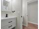 Bathroom with vanity, black faucet, and additional room access at 886 Matthews Ave, New Smyrna Beach, FL 32169