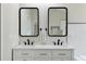 Modern bathroom with double vanity, black matte fixtures, and white subway tile at 886 Matthews Ave, New Smyrna Beach, FL 32169