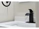 Close-up of a modern black faucet in a bathroom at 886 Matthews Ave, New Smyrna Beach, FL 32169