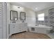 Modern bathroom with double vanity, soaking tub, and patterned tile at 886 Matthews Ave, New Smyrna Beach, FL 32169