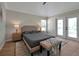 King-size bed, neutral decor, and double doors leading to the backyard at 886 Matthews Ave, New Smyrna Beach, FL 32169