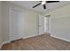 Bedroom with wood-look tile, white closet, and door to hallway at 886 Matthews Ave, New Smyrna Beach, FL 32169