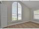 Bright bedroom with large window, plantation shutters, and tile flooring at 886 Matthews Ave, New Smyrna Beach, FL 32169