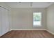 Bedroom with tile floor, window with blinds, and white closet at 886 Matthews Ave, New Smyrna Beach, FL 32169