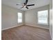 Bright bedroom with tile flooring, ceiling fan, and double windows at 886 Matthews Ave, New Smyrna Beach, FL 32169