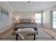 Bright bedroom with a king-size bed, neutral color palette, and access to a patio at 886 Matthews Ave, New Smyrna Beach, FL 32169