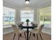 Bright dining area with a round table and four chairs, overlooking the backyard at 886 Matthews Ave, New Smyrna Beach, FL 32169