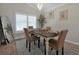 Formal dining room with a wooden table and four chairs, near a window at 886 Matthews Ave, New Smyrna Beach, FL 32169