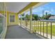 Relaxing front porch with white railing and view of street at 886 Matthews Ave, New Smyrna Beach, FL 32169