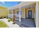 Bright front porch with white railing and gray door at 886 Matthews Ave, New Smyrna Beach, FL 32169