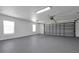 Spacious two-car garage with painted floor and ample storage at 886 Matthews Ave, New Smyrna Beach, FL 32169