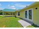 Single story house with covered patio and double doors at 886 Matthews Ave, New Smyrna Beach, FL 32169