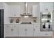 Clean and bright kitchen with white cabinets and stainless steel appliances at 886 Matthews Ave, New Smyrna Beach, FL 32169