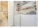 Laundry room with washer, dryer, and shelving at 933 Meadow View Dr # D, Port Orange, FL 32127