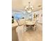 Charming dining area with chandelier and white table at 112 Reserve Cir # 104, Oviedo, FL 32765