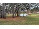 Serene view of a pond surrounded by tall trees and lush greenery at 112 Reserve Cir # 104, Oviedo, FL 32765