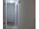 Clean hallway with light walls and tiled flooring at 1908 S Riverside Dr, Edgewater, FL 32141