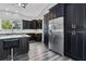 Sleek kitchen with stainless steel refrigerator and dark wood cabinetry at 1975 Spruce Creek Cir, Port Orange, FL 32128