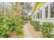 Inviting walkway leading to the home with landscaping at 216 Florida Ave, New Smyrna Beach, FL 32169